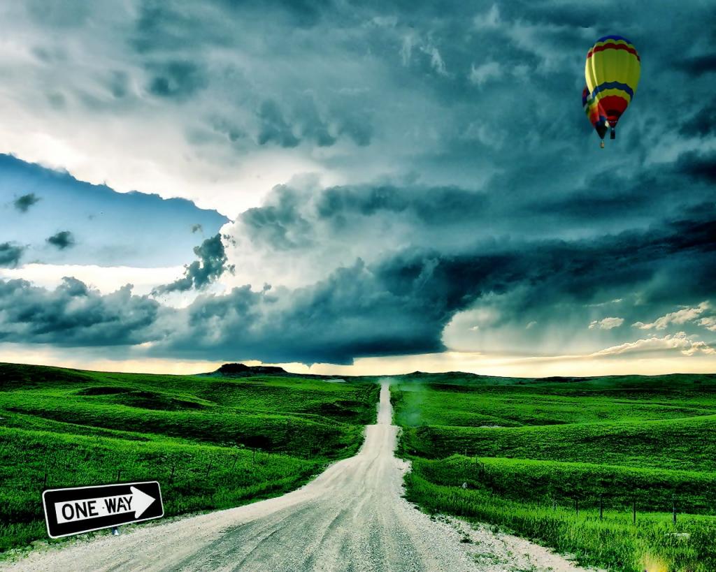 两个黑色和黄色的热空气气球在空中之上在绿草领域之下在灰色云彩期间白天高清壁纸
