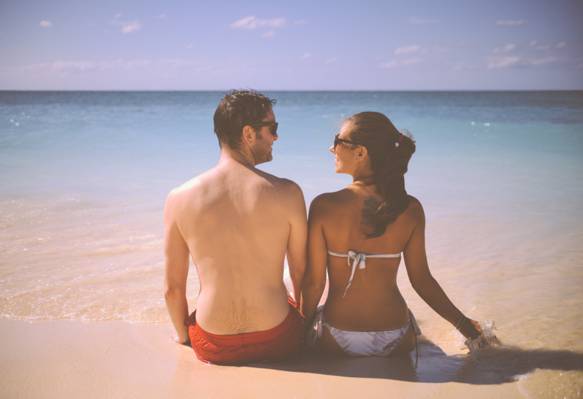 坐在白色旁边的沙子旁边的夫妇白天高清壁纸