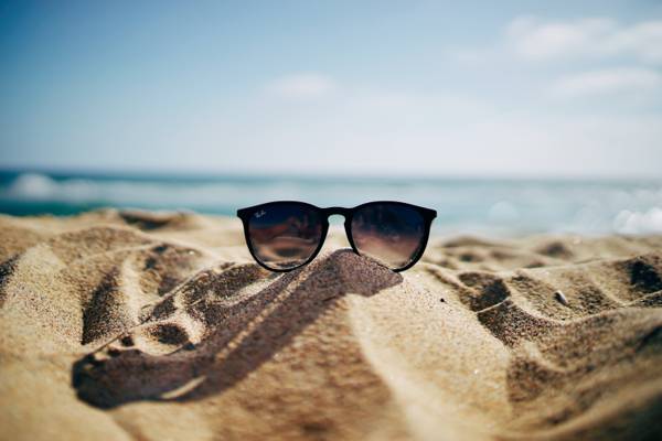 棕色裱框的雷朋旅行者太阳镜棕色的沙子上的照片高清壁纸