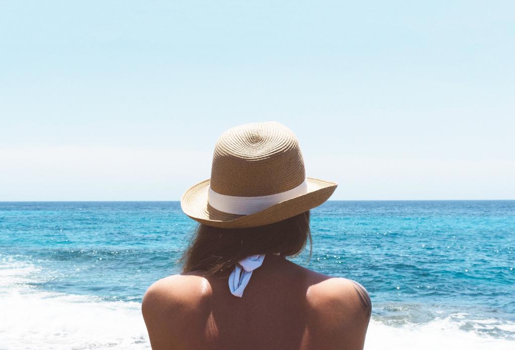 棕色斗帽子站在海边在白天高清壁纸的女人